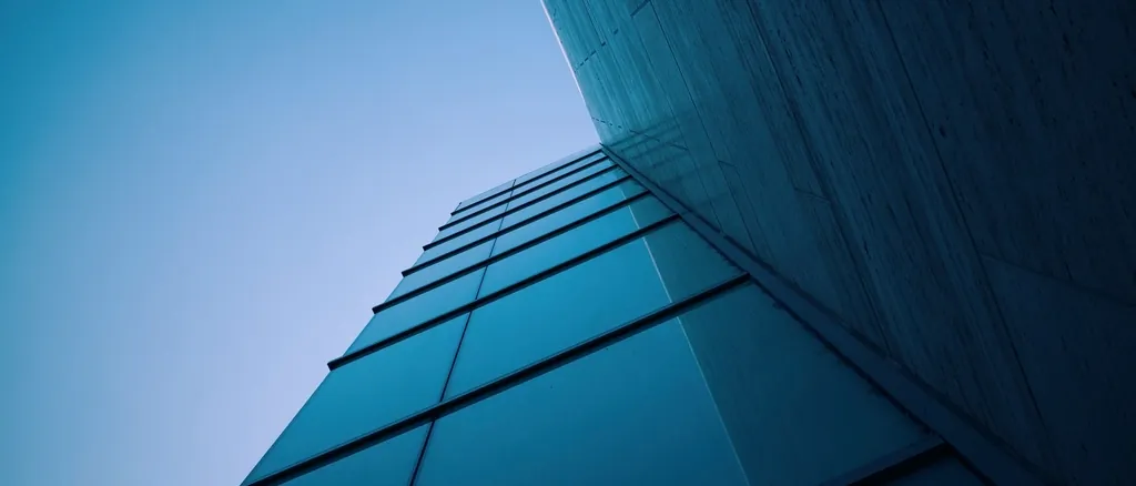 Building facade in deep shade against a clear blue sky