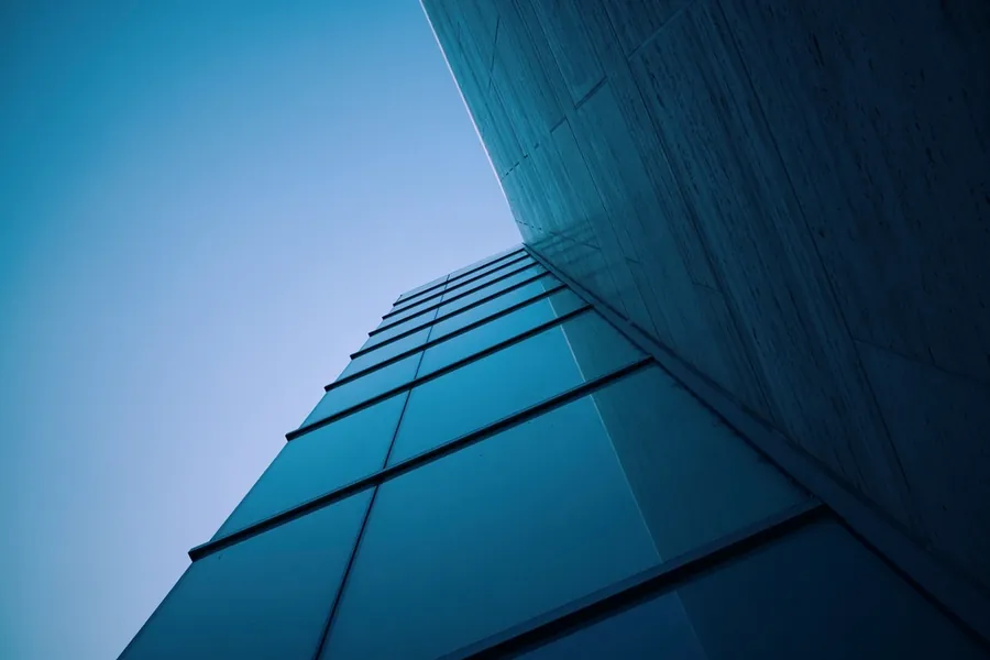 Building facade in deep shade against a clear blue sky