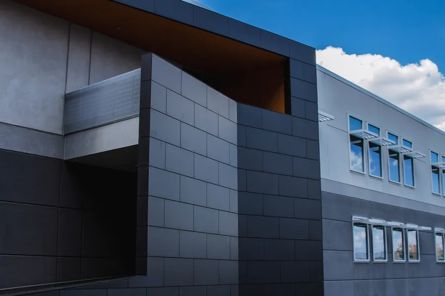 Dark panelled facade of a contemporary building against the sky