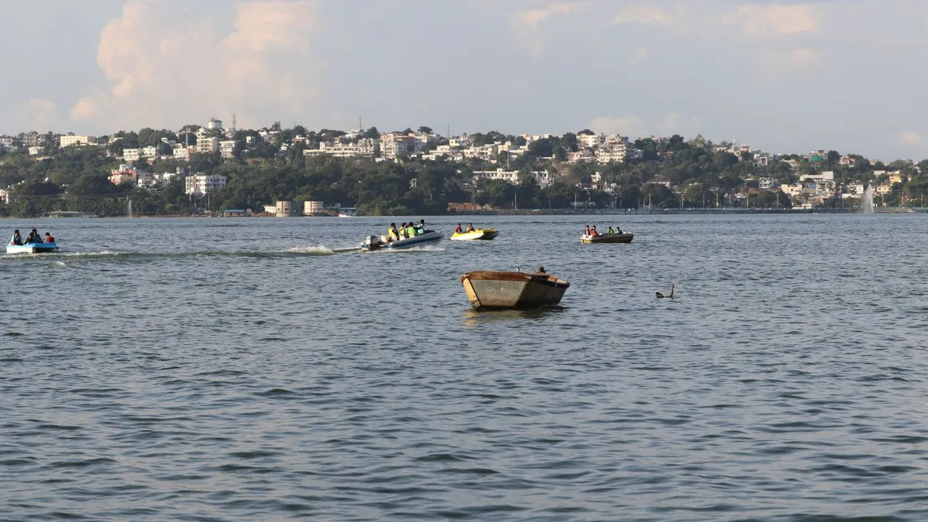 Boats on the Upper Lake in Bhopal with the city skyline on the hills
