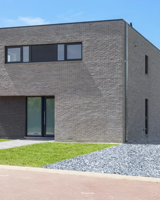 Minimal contemporary house in dark brick with a flat roof