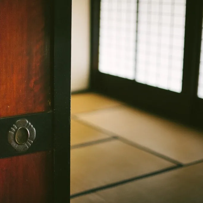 Timber door detail with light filtering through paper screens