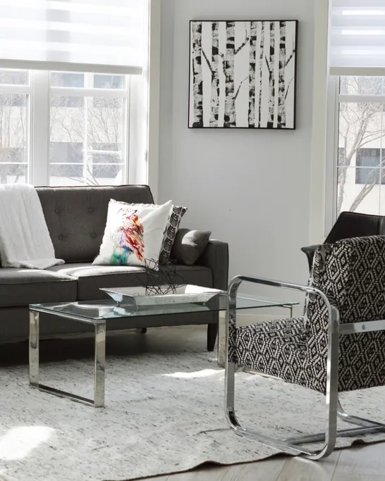 Light-filled living room with grey sofas and large windows