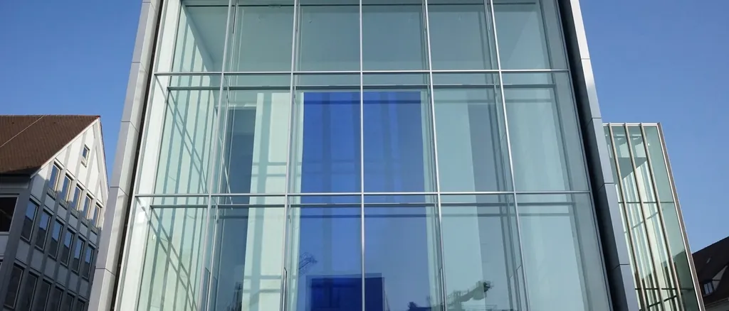 Glass-walled volume cantilevered from a contemporary building